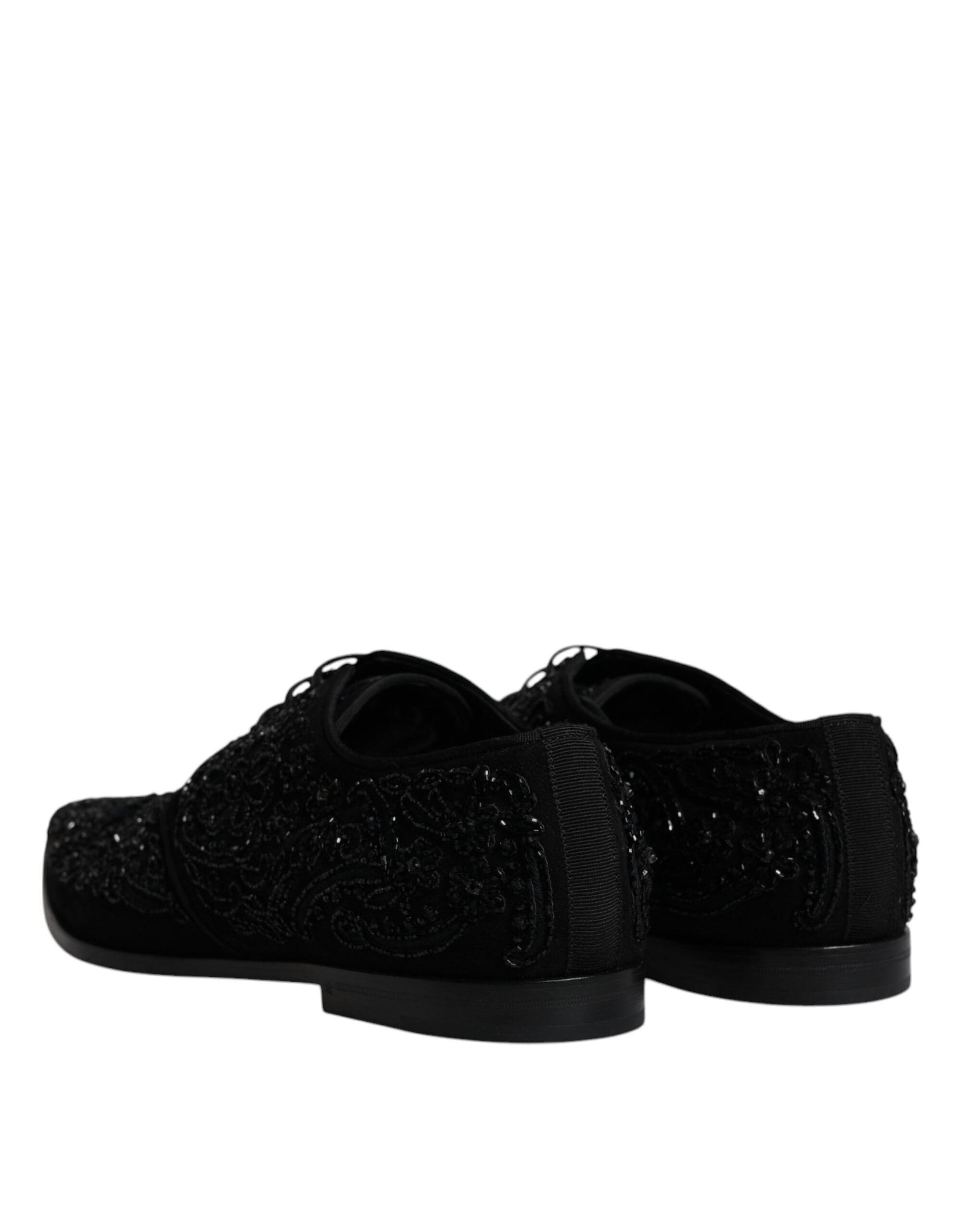 Black embellished suede derby shoes by Dolce & Gabbana with decorative detailing and classic formal design.
