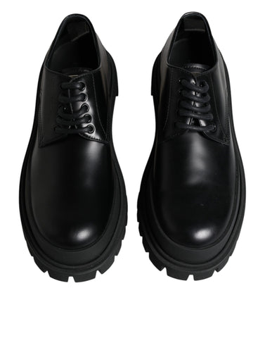 Black leather lace-up trekking dress shoes by Dolce & Gabbana with sturdy soles and sleek design.