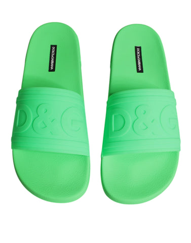 Green leather slides sandals by Dolce & Gabbana, showcasing casual beachwear shoes with open-toe design and slip-on style.