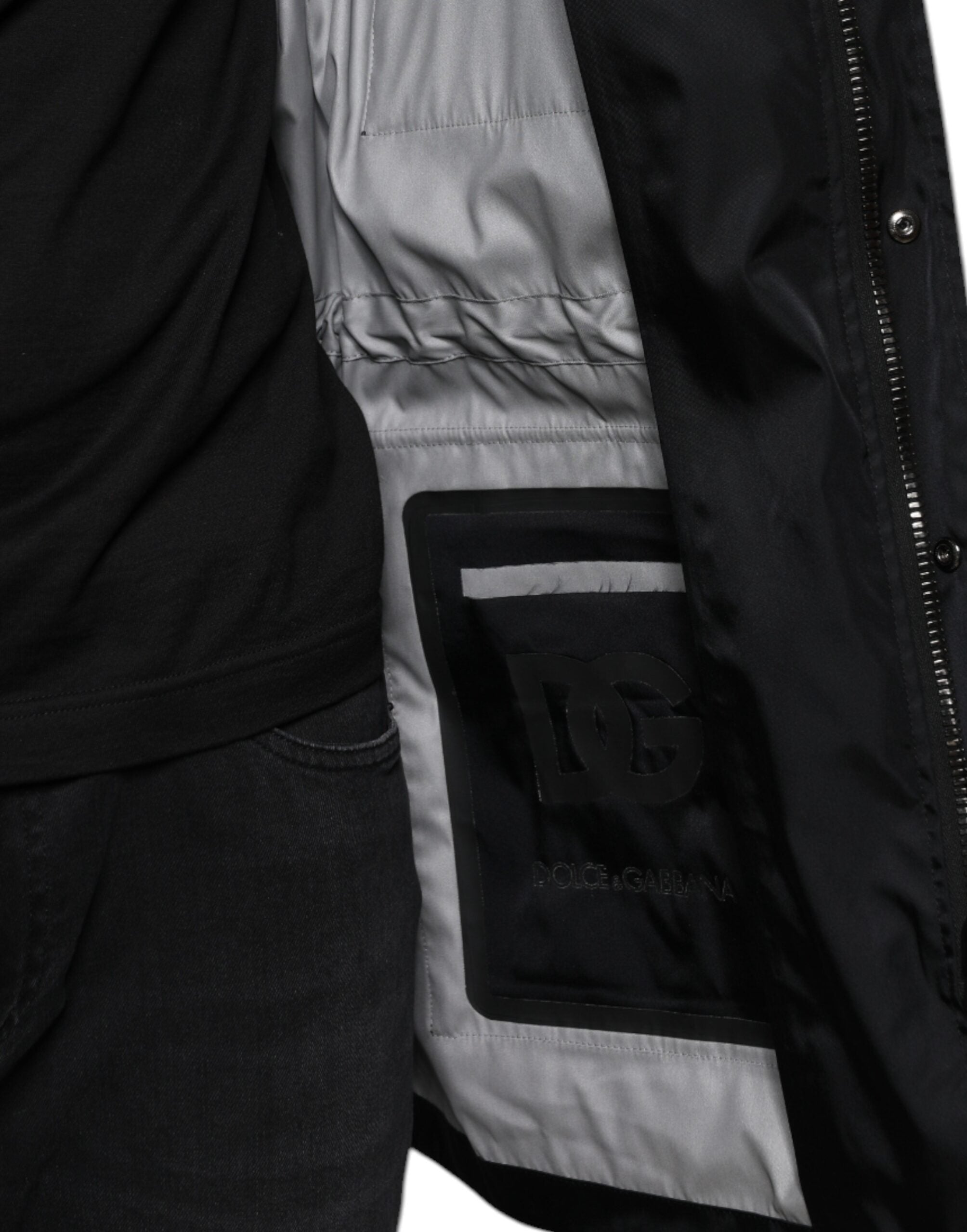 Black nylon winter men's parka coat by Dolce & Gabbana, featuring a hood, front zipper, and insulated design for cold weather.