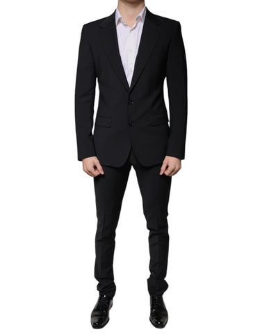 Black wool slim fit formal men’s suit by Dolce & Gabbana, featuring a tailored jacket, matching trousers, and a classic shirt.
