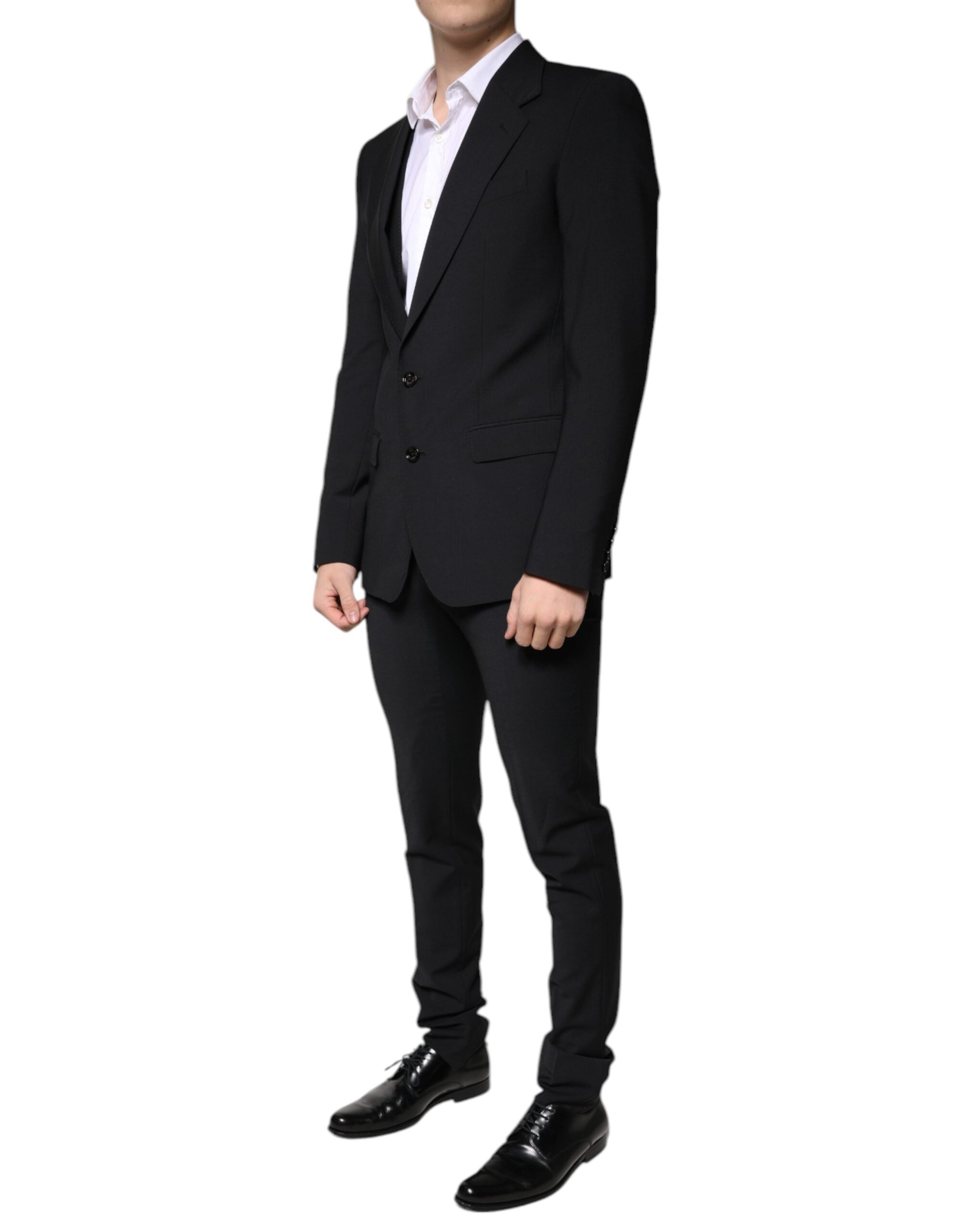 Black wool slim fit men's formal suit by Dolce & Gabbana, consisting of jacket, trousers, and vest, displayed on a mannequin.