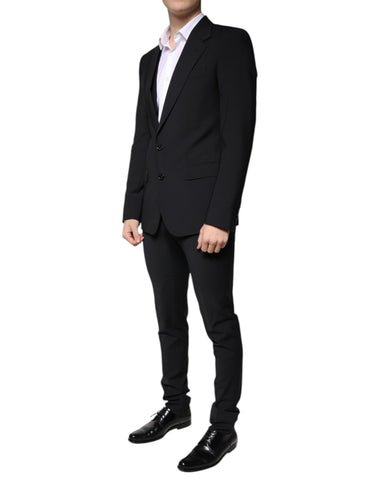 Black wool slim fit men's formal suit by Dolce & Gabbana, consisting of jacket, trousers, and vest, displayed on a mannequin.