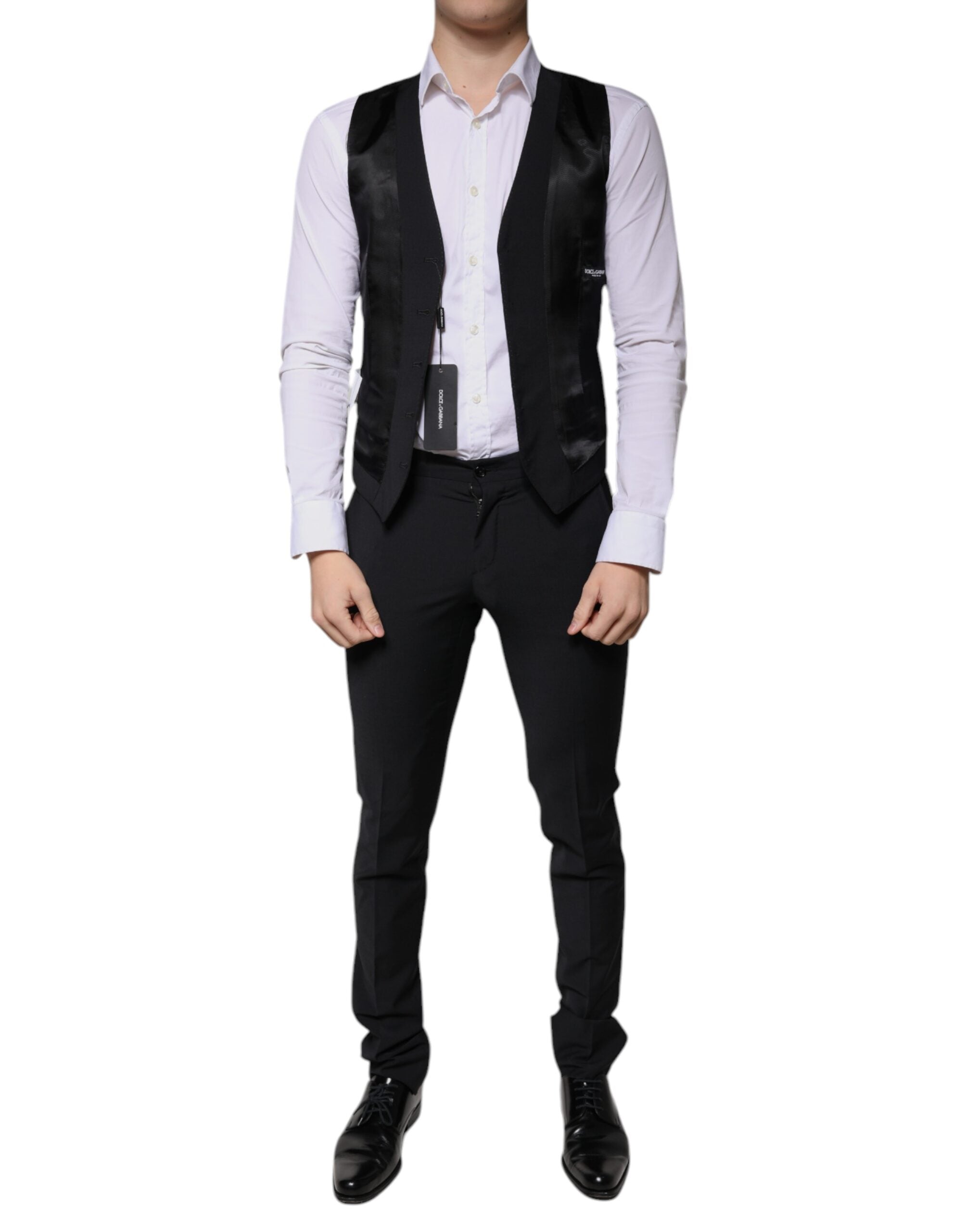 Black wool men's 3-piece slim fit formal suit by Dolce & Gabbana, includes blazer, vest, and trousers, displayed on a hanger.