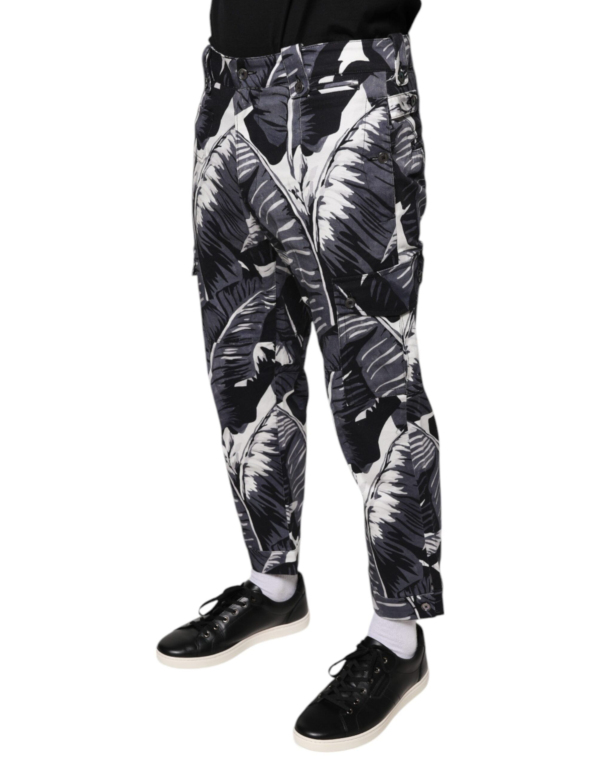 Gray Dolce & Gabbana banana leaf print cotton stretch Capri pants shown on a model. Stylish, fitted ankle-length pants for casual wear.