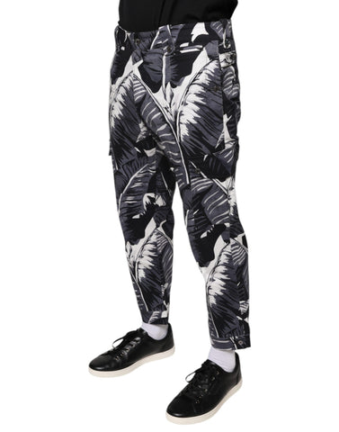Gray Dolce & Gabbana banana leaf print cotton stretch Capri pants shown on a model. Stylish, fitted ankle-length pants for casual wear.