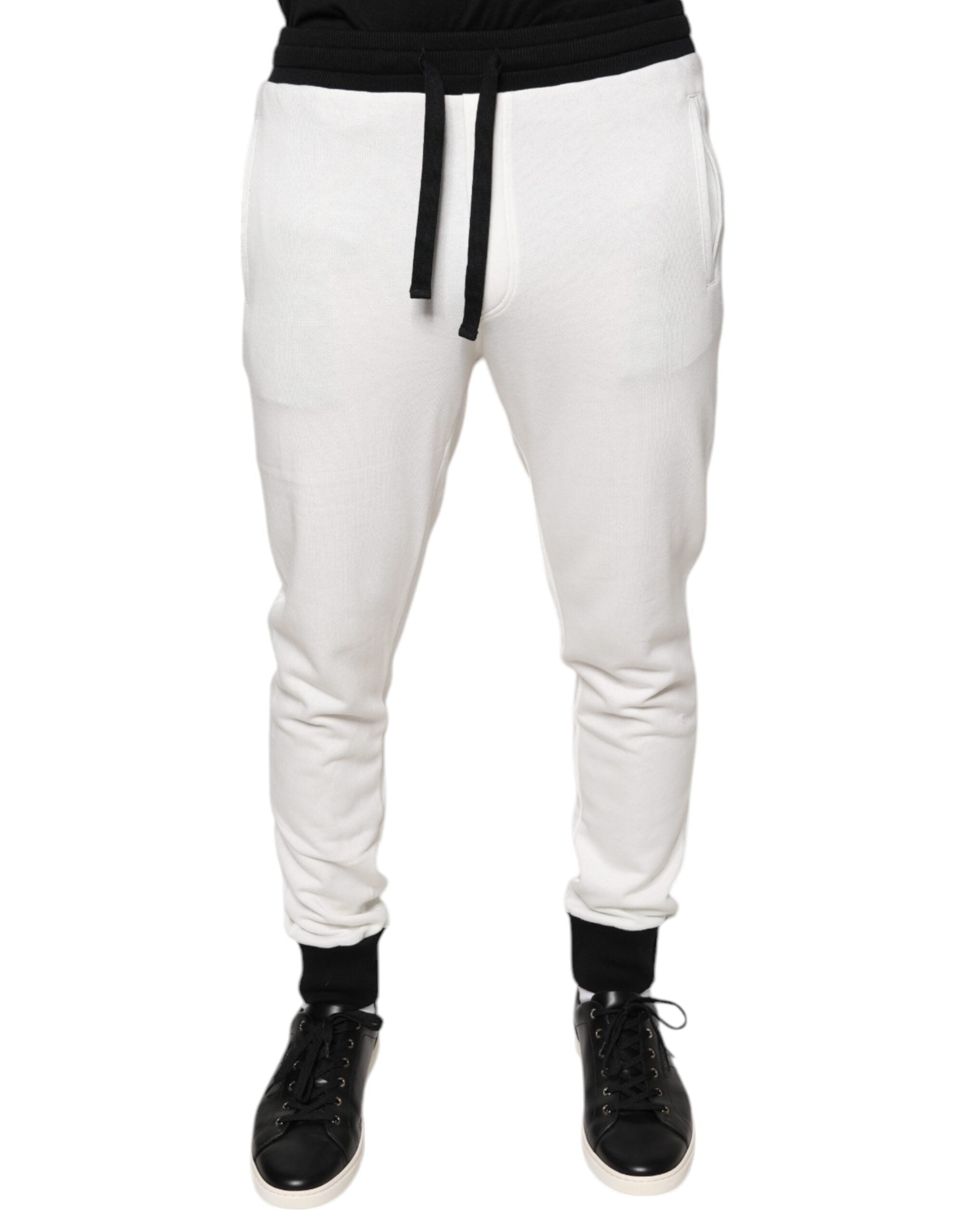 White cotton slim men's jogger sweatpants from Dolce & Gabbana, showing a relaxed fit with elastic cuffs and waistband.