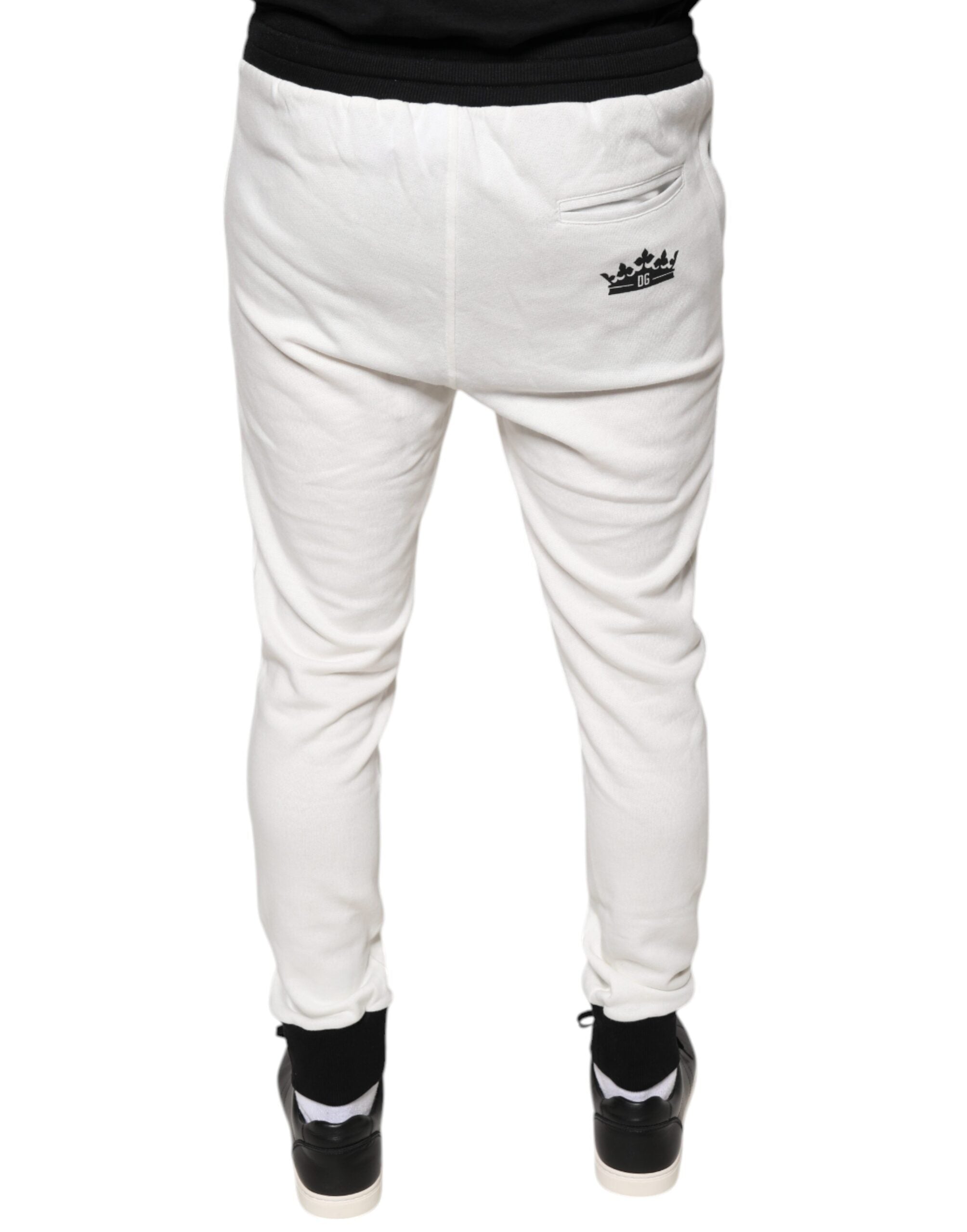 White cotton slim-fit men's jogger sweatpants by Dolce & Gabbana, shown on a model with elastic waistband and cuffed ankles.