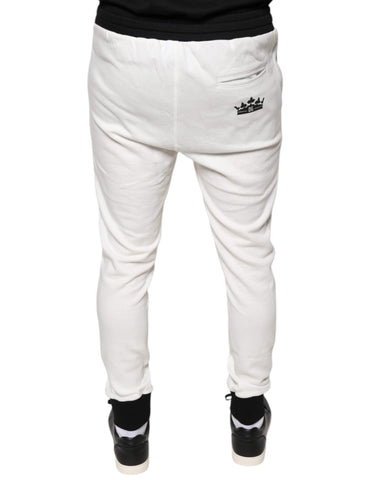 White cotton slim-fit men's jogger sweatpants by Dolce & Gabbana, shown on a model with elastic waistband and cuffed ankles.