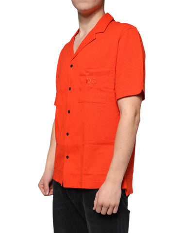 Orange cotton button-down casual polo shirt by Dolce & Gabbana, displayed on a hanger with a close-up of fabric and buttons.