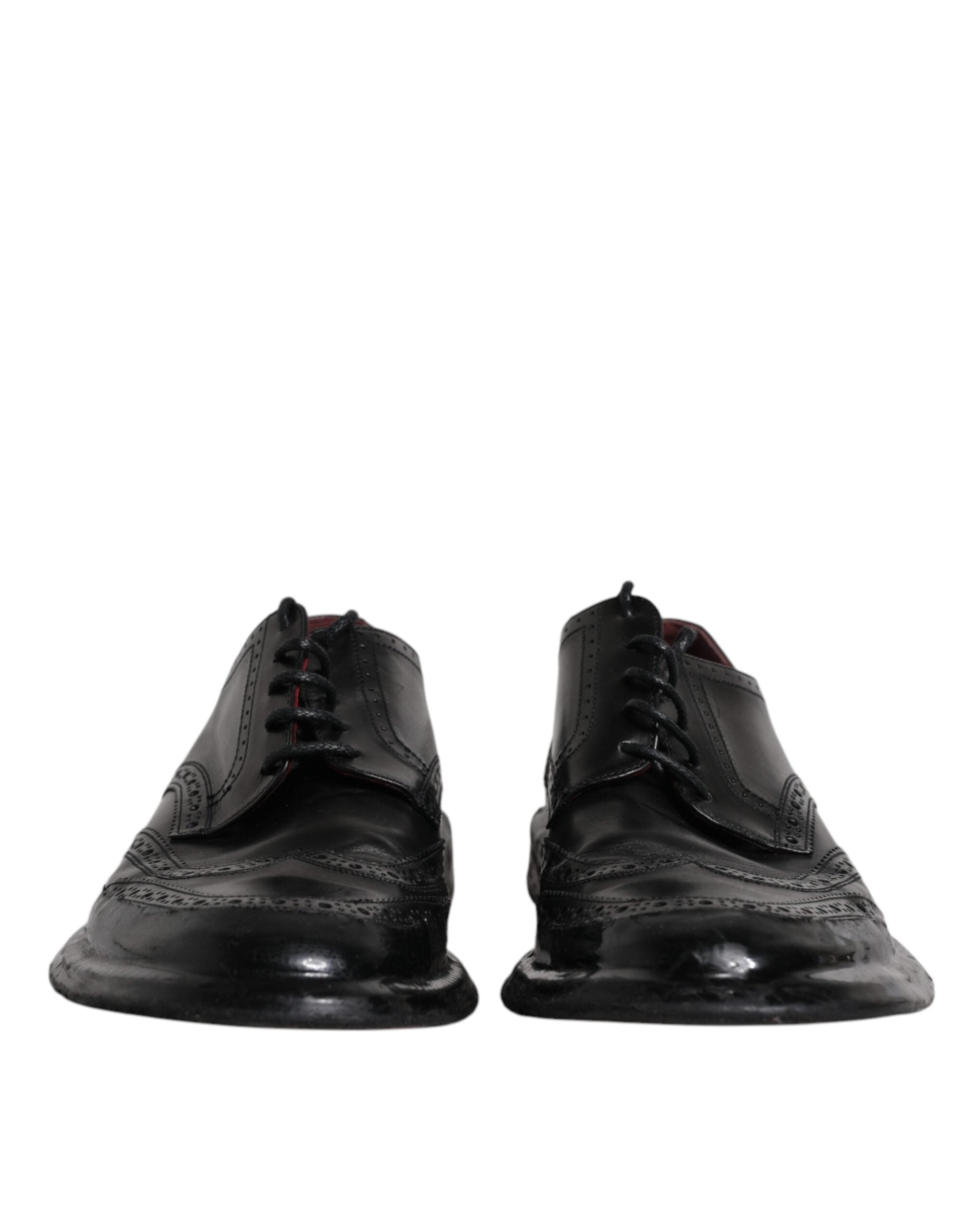 Black leather Derby wingtip formal shoes by Dolce & Gabbana, featuring detailed brogue design and polished finish.