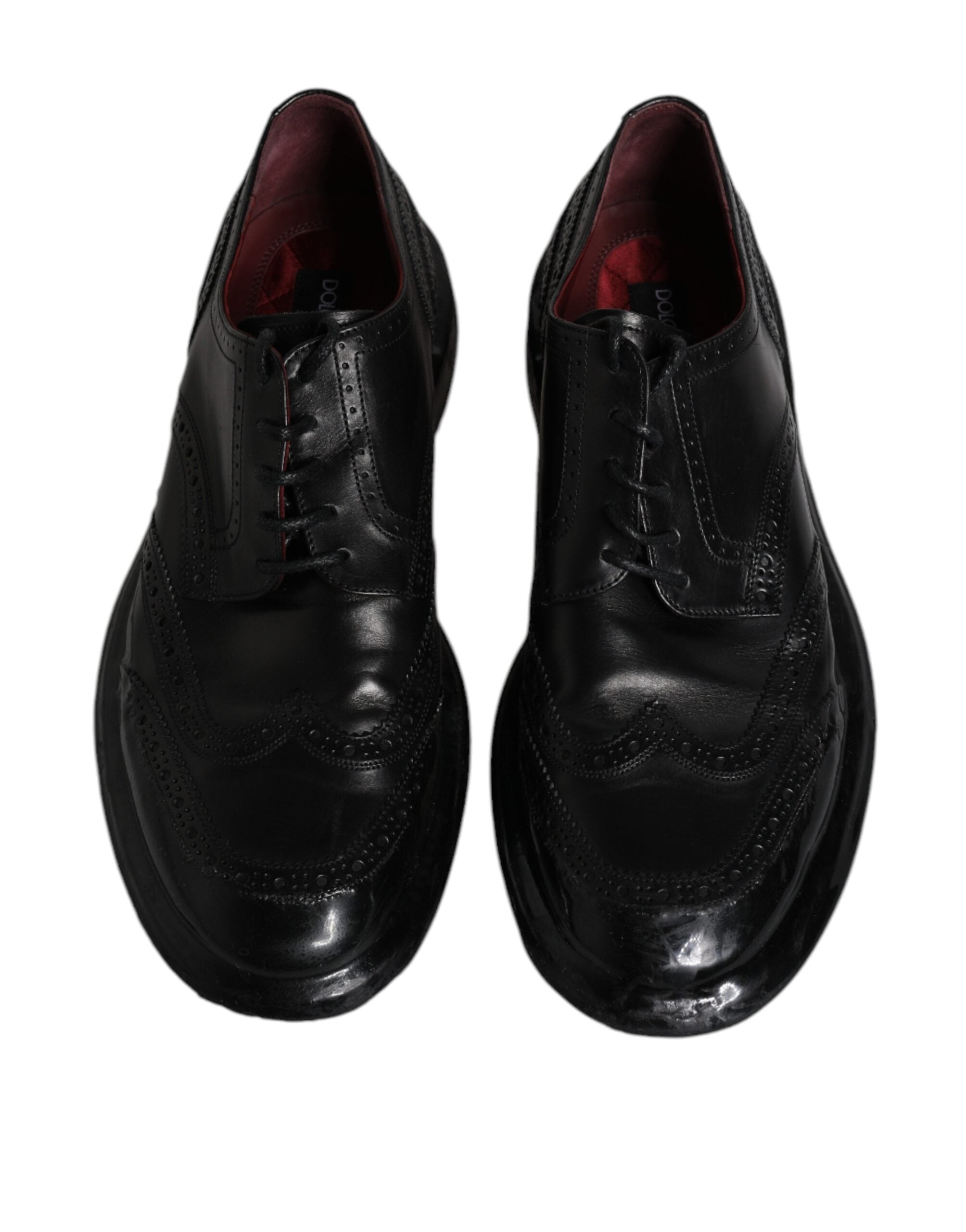 Black leather Derby wingtip formal shoes by Dolce & Gabbana, featuring classic brogue detailing and sleek design.