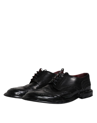 Black leather Derby wingtip formal shoes by Dolce & Gabbana, showing detailed brogue design and polished finish.