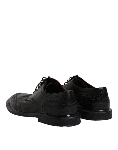 Dolce & Gabbana black leather derby wingtip formal shoes with brogue detailing and polished finish.