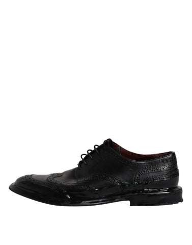 Dolce & Gabbana black leather derby wingtip formal shoes with brogue detailing and classic lace-up design.