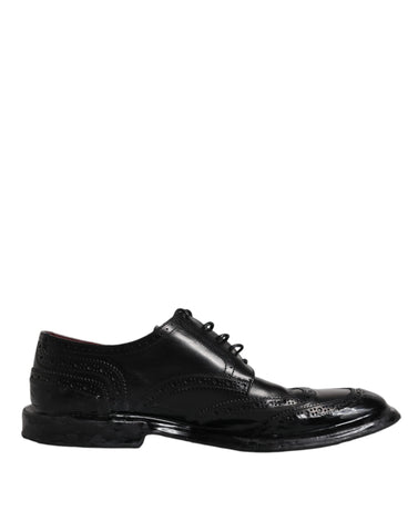 Black leather Derby wingtip formal shoes by Dolce & Gabbana, featuring classic wingtip design and polished finish.