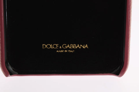 Pink leather Dolce & Gabbana heart crystal phone case with decorative embellishments and cutout for phone camera.
