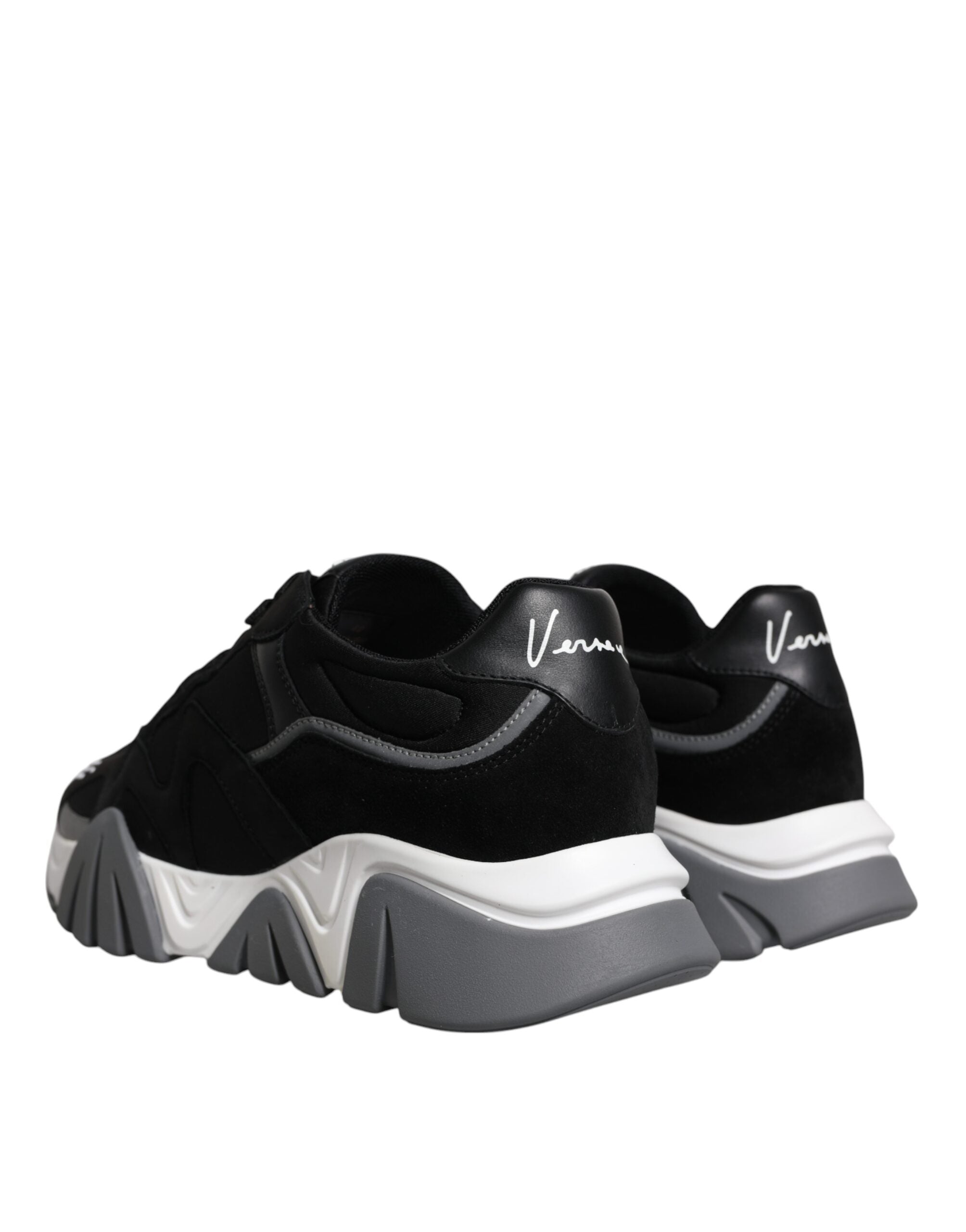 Black leather and neoprene chunky low top sneakers by Versace with thick soles and stylish design.