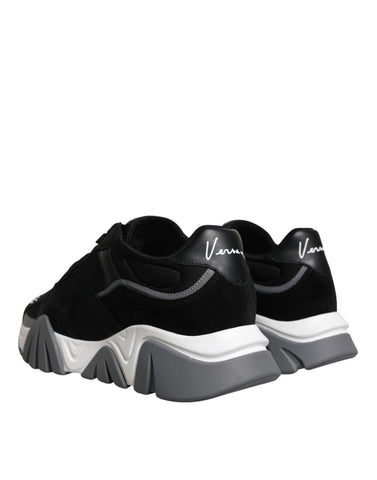 Black leather and neoprene chunky low top sneakers by Versace with thick soles and stylish design.