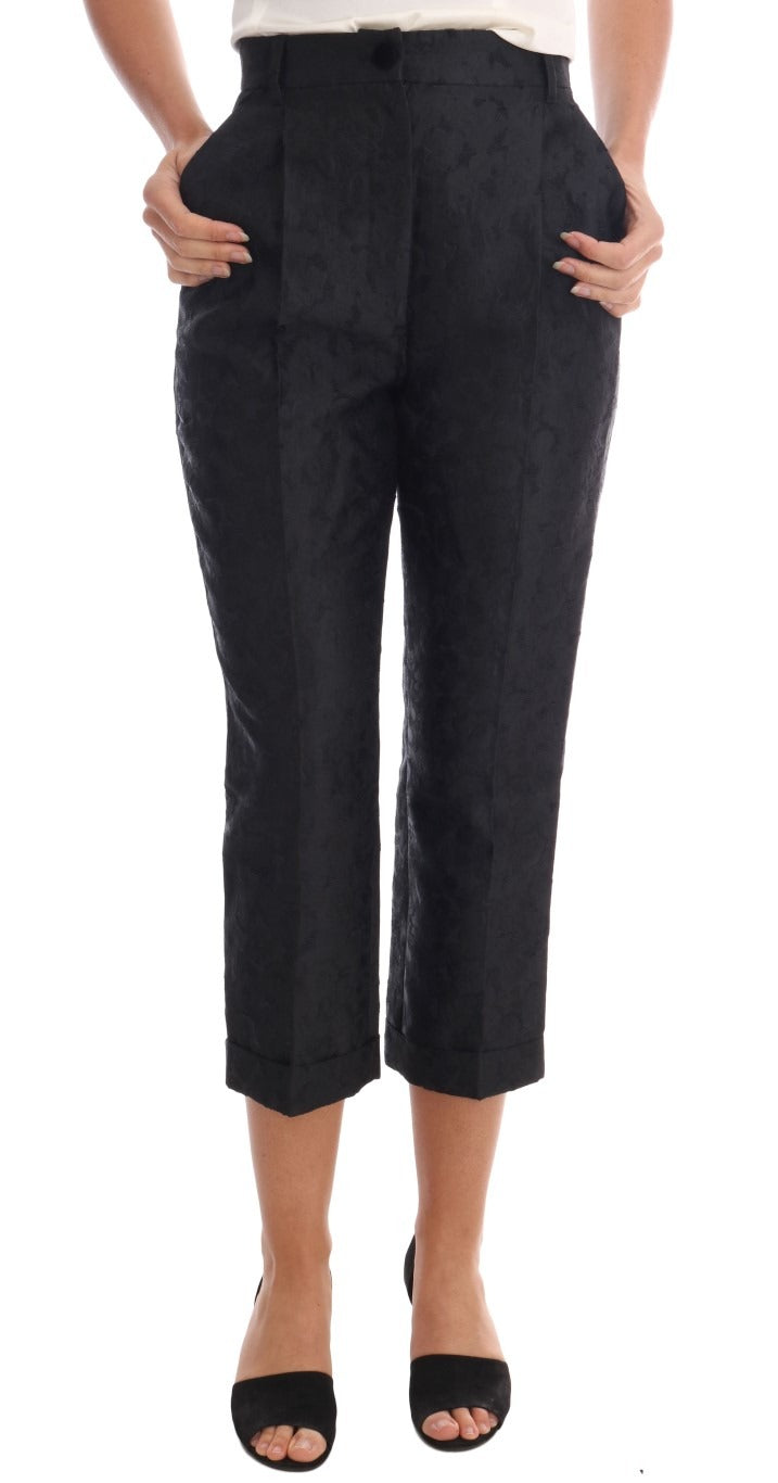 Black floral brocade Capri pants by Dolce & Gabbana, showing detailed fabric pattern and sleek, fitted design.