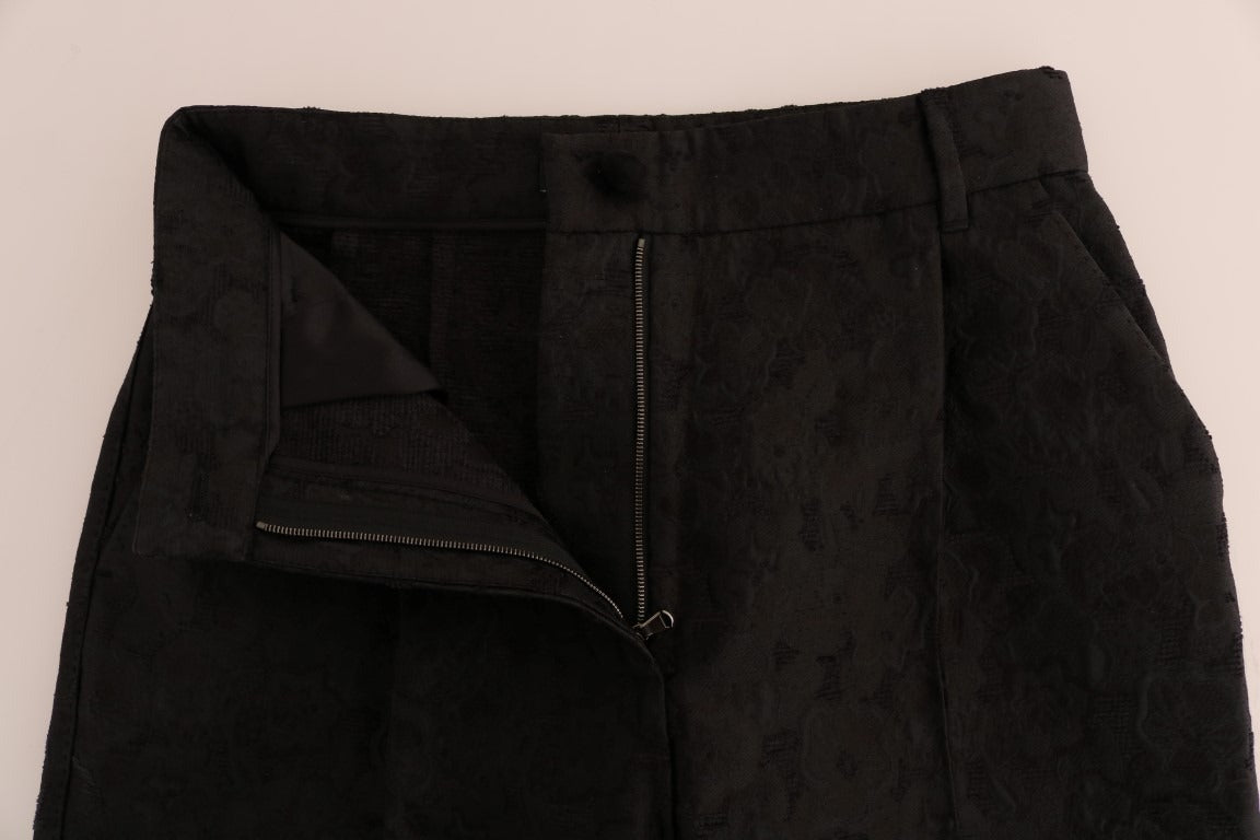 Black floral brocade Capri pants by Dolce & Gabbana featuring a fitted waist and intricate floral pattern.