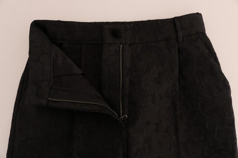 Black floral brocade Capri pants by Dolce & Gabbana featuring a fitted waist and intricate floral pattern.