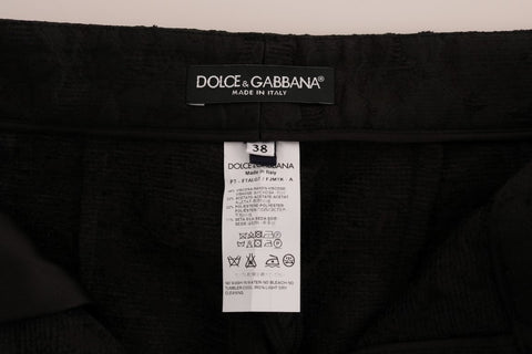Black floral brocade Capri pants by Dolce & Gabbana with intricate floral patterns and tailored fit.
