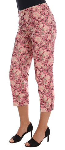 Pink floral brocade Capri pants by Dolce & Gabbana, featuring intricate floral patterns and a tailored fit, displayed on a hanger.