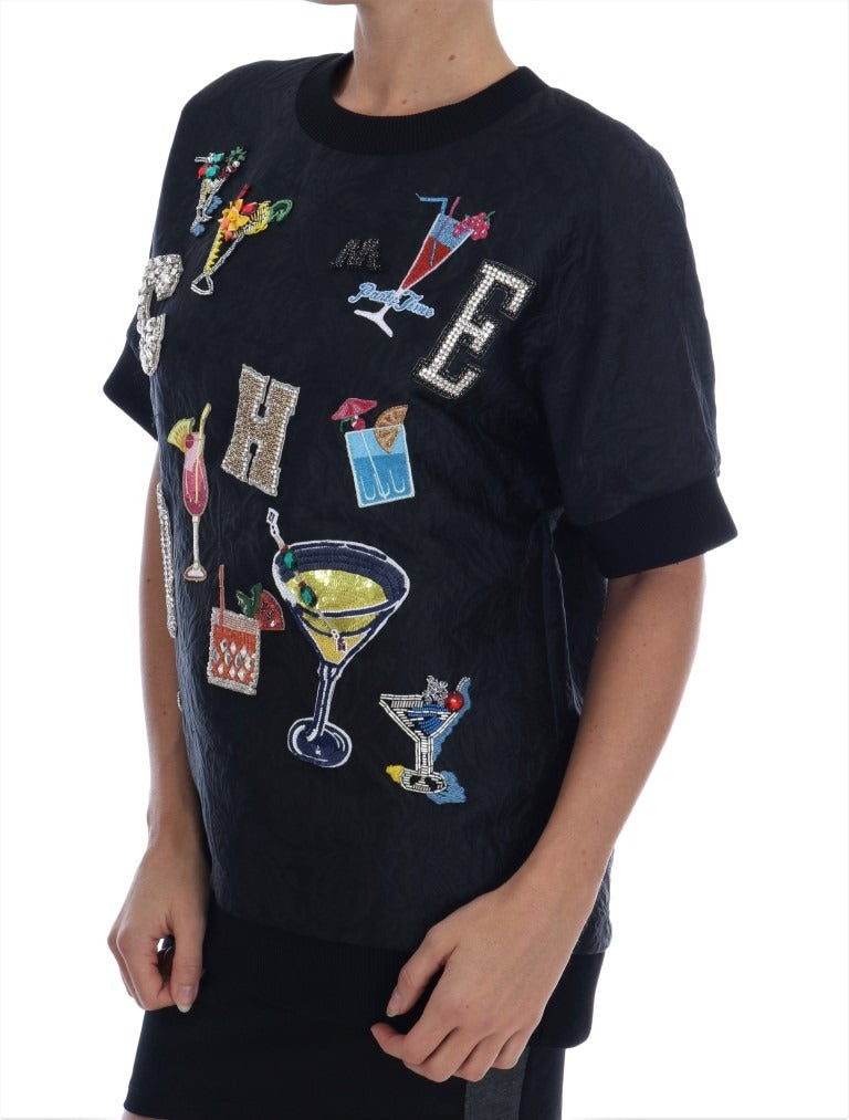 Black brocade cocktail sweater with crystal embellishments by Dolce & Gabbana, featuring intricate embroidery and a stylish fit.