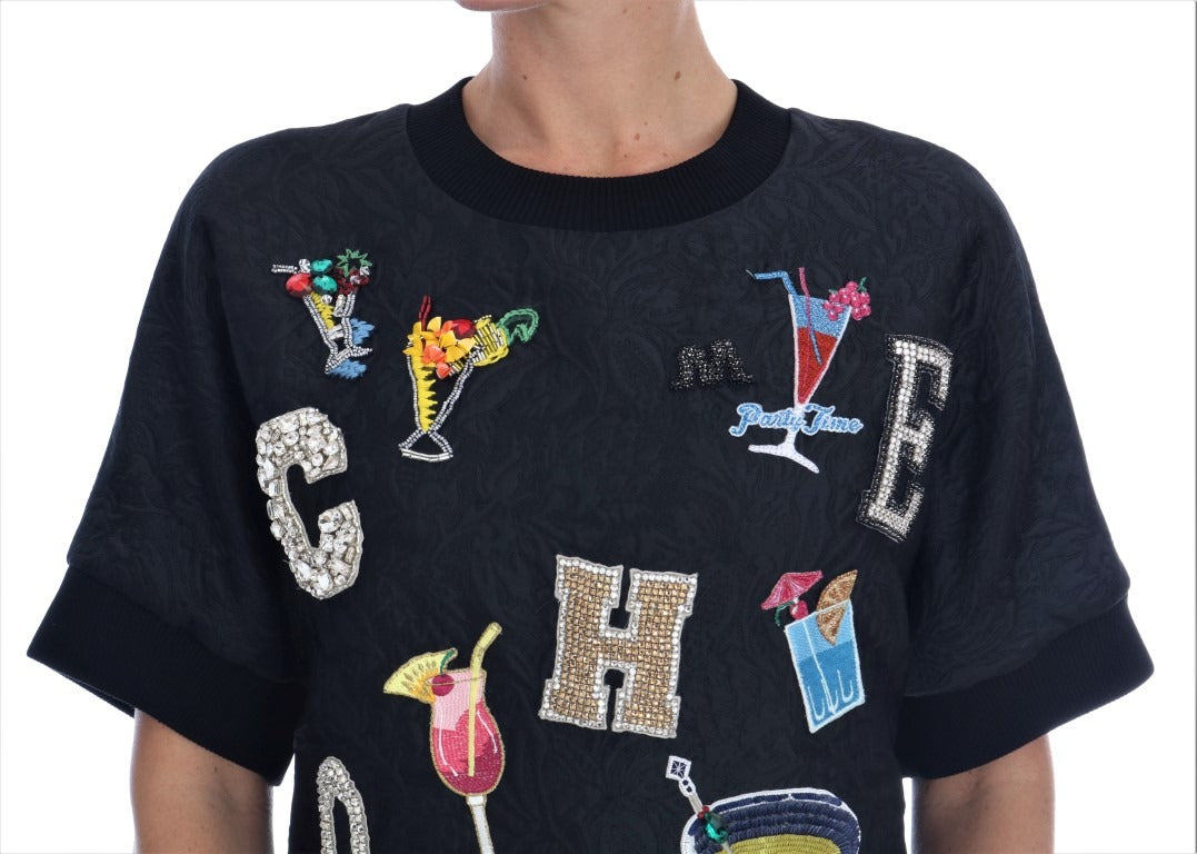 Black brocade cocktail sweater with crystal embellishments by Dolce & Gabbana, featuring intricate fabric and elegant design.