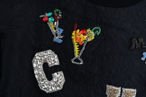 Black brocade cocktail sweater with crystal embellishments by Dolce & Gabbana, displayed on a mannequin.