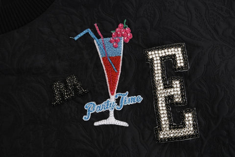 Black brocade cocktail sweater with crystal embellishments from Dolce & Gabbana, featuring intricate fabric design and elegant style.