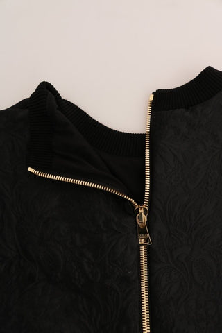 Black brocade Dolce & Gabbana cocktail sweater with crystal embellishments, showcasing intricate fabric and elegant design.