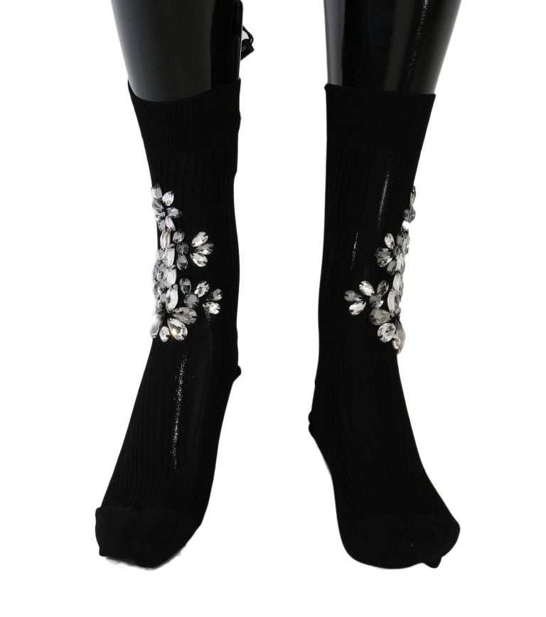 Black knitted floral socks with clear crystal accents by Dolce & Gabbana, featuring intricate floral patterns and transparent embellishments.