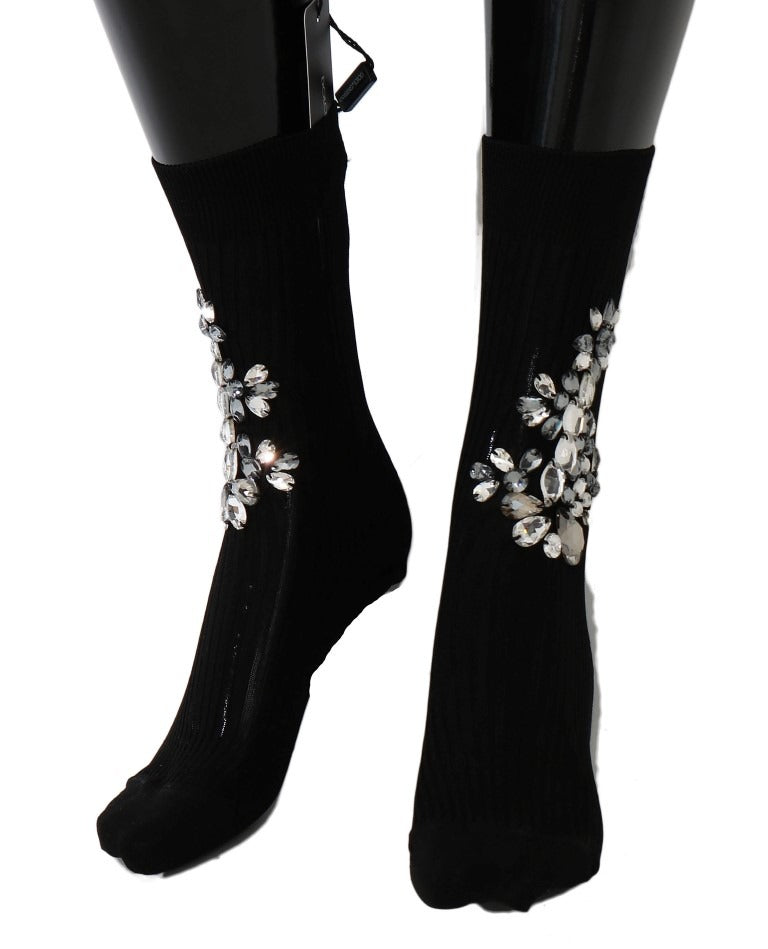 Black knitted floral socks with clear crystal accents by Dolce & Gabbana, featuring intricate floral embroidery and transparent details.
