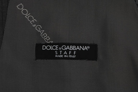 Gray STAFF cotton rayon vest by Dolce & Gabbana, shown on a hanger with a close-up of fabric texture and tailored fit.