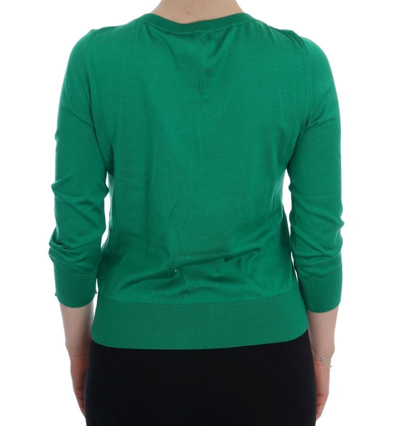 Green silk banana sweater by Dolce & Gabbana featuring crystal embellishments, displayed on a plain background.
