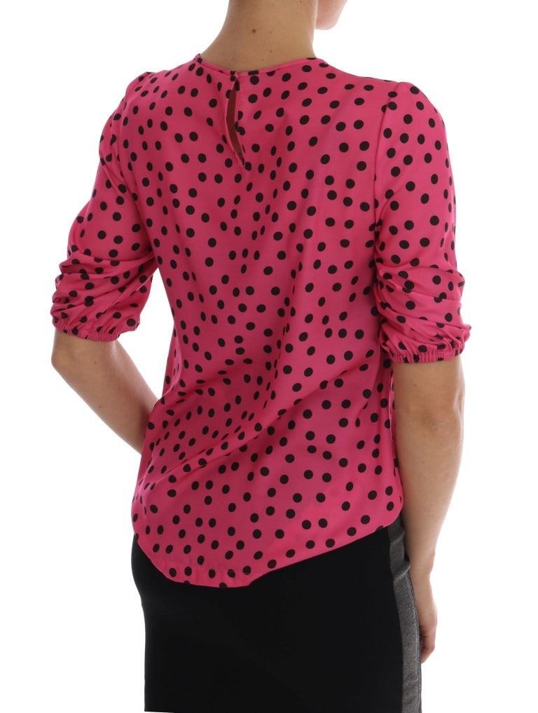 Pink polka dotted silk blouse by Dolce & Gabbana, showing a close-up of the stylish, lightweight fabric and classic design.