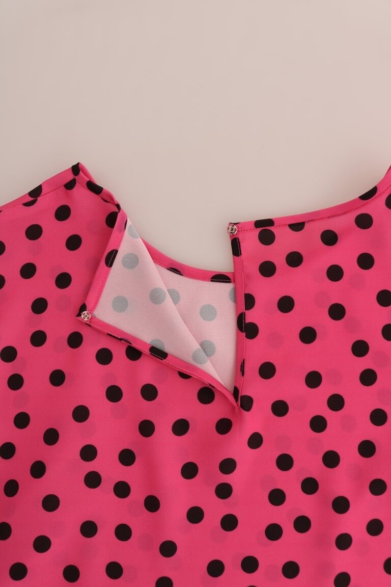 Pink polka dotted silk blouse by Dolce & Gabbana, shown with long sleeves and a classic collar, displayed on a hanger.