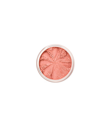 Lily Lolo mineral blush in Clementine, a vibrant orange shade, displayed in a compact with natural light highlighting its color.