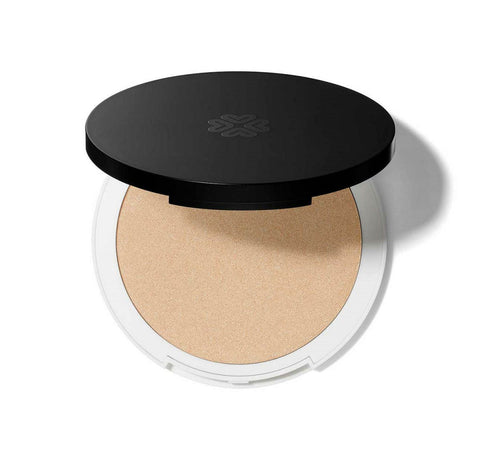 Lily Lolo Mineral Illuminator in Champagne by Jag Couture London - New York, featuring a compact with shimmering highlighter powder.