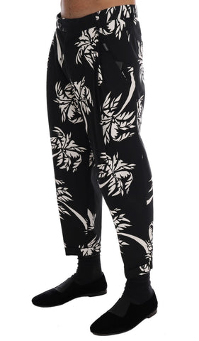 Black cotton stretch pants by Dolce & Gabbana featuring a fitted style and subtle tree motif design.
