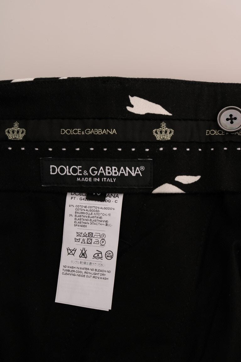 Black Cotton Stretch Pants by Dolce & Gabbana, featuring a fitted waist and sleek design, displayed on a hanger against a white background.