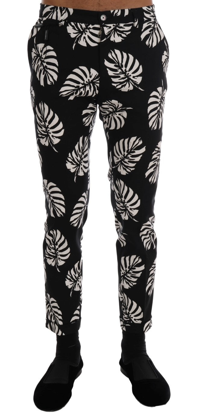 White and black leaf print cotton stretch slim pants by Dolce & Gabbana, featuring a tailored fit and stylish design.