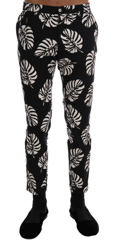 White and black leaf print cotton stretch slim pants by Dolce & Gabbana, featuring a tailored fit and stylish design.
