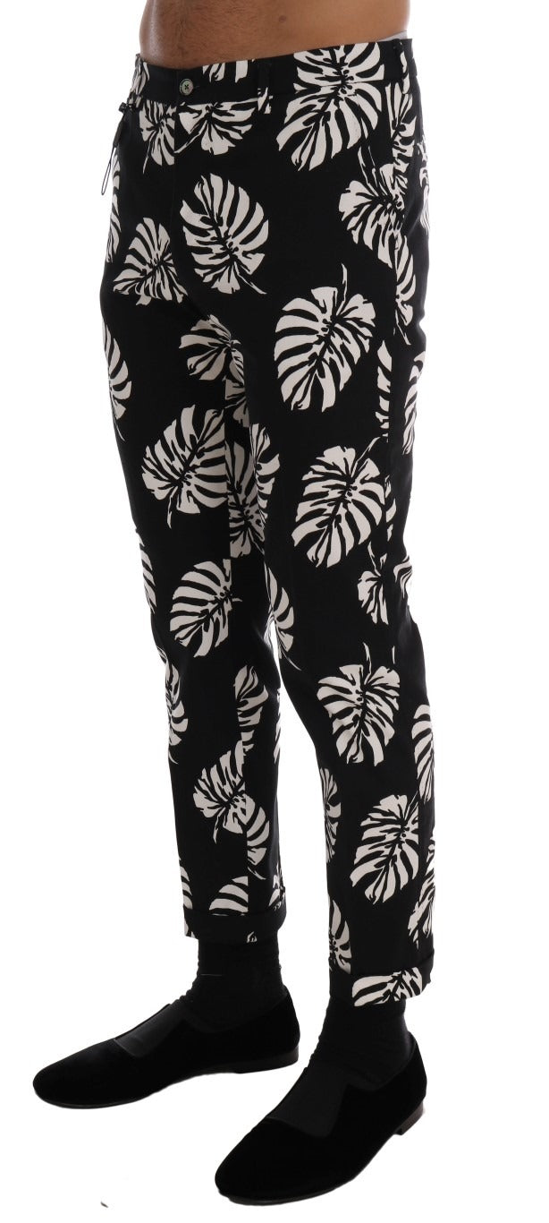 White and black leaf print cotton stretch slim pants by Dolce & Gabbana, featuring a tailored fit and leaf pattern design.