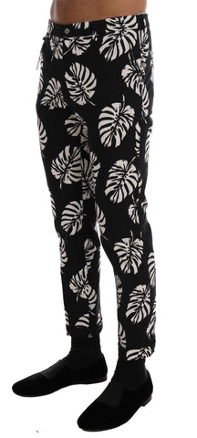White and black leaf print cotton stretch slim pants by Dolce & Gabbana, featuring a tailored fit and leaf pattern design.