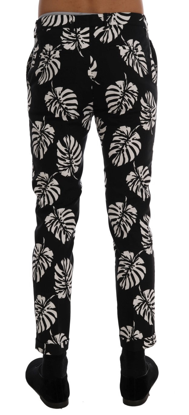 White and black leaf print cotton stretch slim pants from Dolce & Gabbana, featuring a fitted design and stylish pattern.