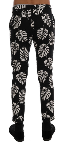 White and black leaf print cotton stretch slim pants from Dolce & Gabbana, featuring a fitted design and stylish pattern.