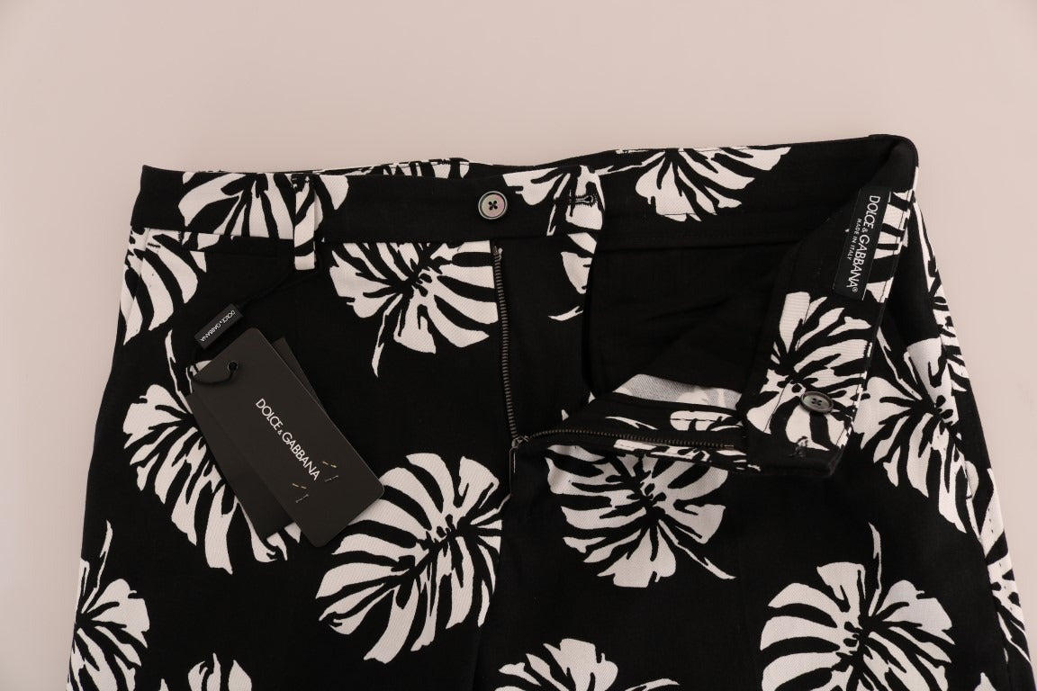 White and black leaf print cotton stretch slim pants by Dolce & Gabbana, featuring a tailored fit and stylish leaf pattern.
